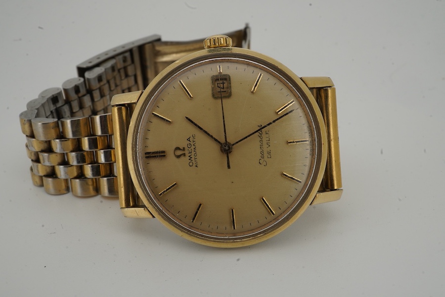 A gentleman's 1960's? steel and gold plated Omega Seamaster De Ville Automatic wrist watch, with baton numerals and date aperture, case diameter 35mm, on an associated gold plated steel bracelet(worn), no box or papers.